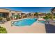Beautiful community pool and spa with ample seating and lush landscaping, perfect for relaxation and recreation at 4241 N Pebblecreek Pkwy # 7, Goodyear, AZ 85395