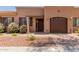 Charming single-story home featuring beautiful landscaping, a private garage, and a welcoming front entry at 4241 N Pebblecreek Pkwy # 7, Goodyear, AZ 85395