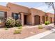 Inviting single-story home showcases desert landscaping, a private garage, and a covered front entrance at 4241 N Pebblecreek Pkwy # 7, Goodyear, AZ 85395