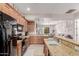 Open kitchen featuring granite countertops, stainless steel appliances, and a breakfast bar at 4241 N Pebblecreek Pkwy # 7, Goodyear, AZ 85395