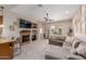Bright living room features a stone fireplace, comfortable seating, and sliding glass doors to the patio at 4241 N Pebblecreek Pkwy # 7, Goodyear, AZ 85395