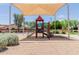 Community playground with shade structure and play equipment, perfect for outdoor activities at 4241 N Pebblecreek Pkwy # 7, Goodyear, AZ 85395