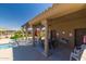 Community pool with seating and shaded area for relaxing on a sunny day at 4241 N Pebblecreek Pkwy # 7, Goodyear, AZ 85395