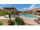 Beautiful community pool area surrounded by palm trees, offering a relaxing oasis for residents to enjoy at 4241 N Pebblecreek Pkwy # 7, Goodyear, AZ 85395