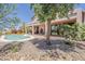 Private backyard with pool, covered patio, and desert landscaping at 4293 S Columbine Way, Gold Canyon, AZ 85118