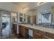 A full bathroom with double vanity, two sinks, mirrors, and dark cabinets at 4293 S Columbine Way, Gold Canyon, AZ 85118