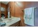 Half bathroom with wood vanity, sink, and decorative mirror at 4293 S Columbine Way, Gold Canyon, AZ 85118