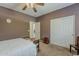 Bedroom featuring a neutral carpet, ceiling fan, and a mirrored closet at 4293 S Columbine Way, Gold Canyon, AZ 85118