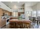 Bright kitchen features tile floors, stainless appliances, eat-in island and connected dining area at 4293 S Columbine Way, Gold Canyon, AZ 85118