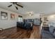 Spacious living area with a wooden floor, black furniture and a large tv at 4293 S Columbine Way, Gold Canyon, AZ 85118