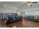 Spacious living area with a wooden floor, black furniture and TV at 4293 S Columbine Way, Gold Canyon, AZ 85118