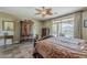 Spacious main bedroom with ceiling fan, access to the patio and pool, and decorative furniture at 4293 S Columbine Way, Gold Canyon, AZ 85118