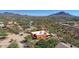 An aerial view of a desert neighborhood, blending homes with the surrounding natural landscape and mountain views at 44421 N 12Th St, New River, AZ 85087