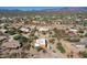 Aerial view of the desert landscape showcasing houses with desert landscaping nestled within the natural environment at 44421 N 12Th St, New River, AZ 85087