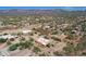 Expansive aerial view of desert neighborhood with mountain views and homes with generous yard sizes at 44421 N 12Th St, New River, AZ 85087