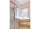 Bathroom featuring a glass shower, a jacuzzi tub, tile floors, and a window for natural lighting at 44421 N 12Th St, New River, AZ 85087