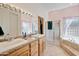 Bathroom boasting dual sinks, granite countertops, decorative wall paint, and a glass-enclosed shower at 44421 N 12Th St, New River, AZ 85087