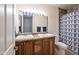 Bathroom featuring double vanity, granite counters and decorative shower curtain at 44421 N 12Th St, New River, AZ 85087