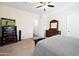 Bedroom featuring carpet flooring, neutral walls, ceiling fan, and a wooden dresser with a TV at 44421 N 12Th St, New River, AZ 85087