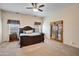 A spacious bedroom featuring a ceiling fan, carpet and french doors at 44421 N 12Th St, New River, AZ 85087