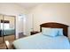 Bedroom with a ceiling fan, a mirrored closet, and a doorway leading to another room at 44421 N 12Th St, New River, AZ 85087