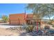 Inviting Southwestern-style home with a desert landscape, an American flag, and a three-car garage at 44421 N 12Th St, New River, AZ 85087