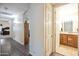 Hallway with wood floors leading to a bedroom and an open doorway to a bathroom at 44421 N 12Th St, New River, AZ 85087