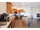 Spacious kitchen with stainless appliances, wooden cabinets, granite counters, and island at 44421 N 12Th St, New River, AZ 85087