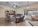 Comfortable living room with ceiling fan, tv, and beautiful desert views at 44421 N 12Th St, New River, AZ 85087