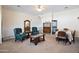 Neutral-toned living room with traditional furnishings, ceiling fan, and dining area at 44421 N 12Th St, New River, AZ 85087