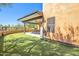 A covered patio featuring an outdoor table and chairs set with desert views and artificial grass at 44421 N 12Th St, New River, AZ 85087