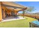 A covered patio featuring an outdoor table and chairs set with desert views at 44421 N 12Th St, New River, AZ 85087