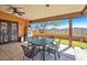A covered patio featuring a metal table and chairs set with views of the desert landscape at 44421 N 12Th St, New River, AZ 85087