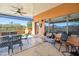 A covered patio featuring a table with chairs, built-in speakers and views of the desert landscape at 44421 N 12Th St, New River, AZ 85087