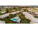 Community aerial view highlighting the beautifully maintained green spaces, pool, and surrounding palm trees at 446 S 77Th St, Mesa, AZ 85208