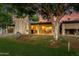 Lush green backyard with patio furniture and outdoor grill perfect for entertaining at 446 S 77Th St, Mesa, AZ 85208