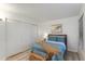 This bedroom features light-colored floors, large closet, and bed with a woven trunk in front of it at 446 S 77Th St, Mesa, AZ 85208