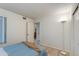 This bedroom features light-colored floors and a bed with an open door leading to another room at 446 S 77Th St, Mesa, AZ 85208