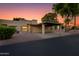 Charming single-story home with a covered carport and well-maintained landscaping at sunset at 446 S 77Th St, Mesa, AZ 85208