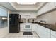 Updated kitchen featuring white cabinetry and modern appliances; black fridge at 446 S 77Th St, Mesa, AZ 85208