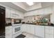 Well-maintained kitchen with white cabinets and modern appliances and dark countertops at 446 S 77Th St, Mesa, AZ 85208