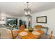 Open concept living room and dinning space features cozy seating, and view to the backyard at 446 S 77Th St, Mesa, AZ 85208