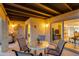 Inviting outdoor patio featuring a table, chairs, and access to the interior at 446 S 77Th St, Mesa, AZ 85208