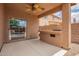 Covered patio with bar area and a view of the backyard pool, lush landscaping, and blue skies at 45309 W Gavilan Dr, Maricopa, AZ 85139