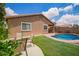 Landscaped backyard featuring a well-maintained pool, patio area, and comfortable outdoor seating at 45309 W Gavilan Dr, Maricopa, AZ 85139