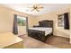 Bedroom with a large bed, ceiling fan, and natural light, creating a relaxing atmosphere at 45309 W Gavilan Dr, Maricopa, AZ 85139