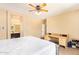 Bedroom featuring ceiling fan, a desk and a view of an ensuite bathroom at 45309 W Gavilan Dr, Maricopa, AZ 85139