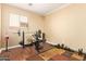 Exercise room with workout equipment and laminated wood floors at 45309 W Gavilan Dr, Maricopa, AZ 85139