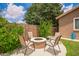 Cozy backyard fire pit area with comfortable seating, lush landscaping, and a privacy wall at 45309 W Gavilan Dr, Maricopa, AZ 85139