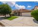 Lovely single-story home featuring lush landscaping, a well-manicured lawn, and a Southwestern-style facade at 45309 W Gavilan Dr, Maricopa, AZ 85139